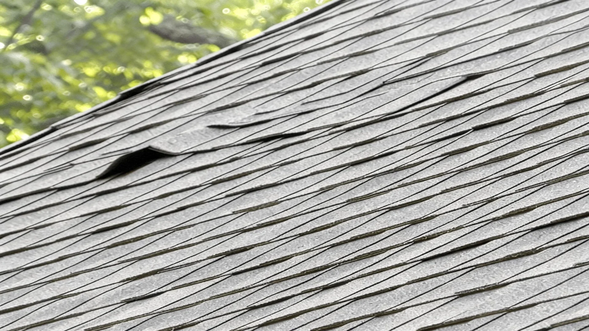 buckled asphalt shingle repair Des Moines Iowa