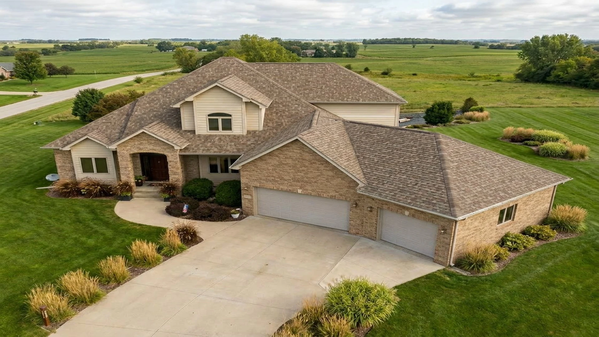 Brick home with new architectural shingle roof in Earlham, Iowa by Xtreme Roofing & Siding
